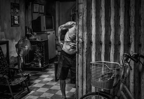 ressed in well-pressed shorts, this elderly gentleman moves through his day, baring his ribbed torso to cope with the stifling heat.