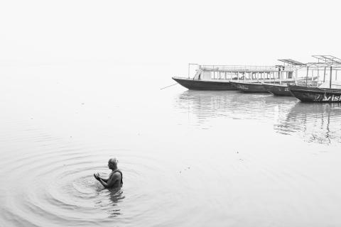 At dawn in Varanasi, devotees bathe in the sacred Ganges River to cleanse themselves of sin and attain spiritual purification