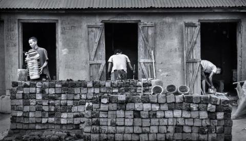 Men working making cooking pots with no safety equipment