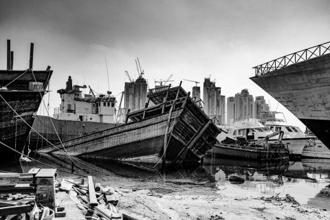 A black and white image of a docked wreckage of a boat