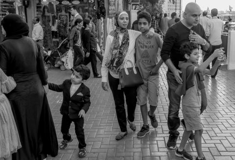 Random people walking down a street market  