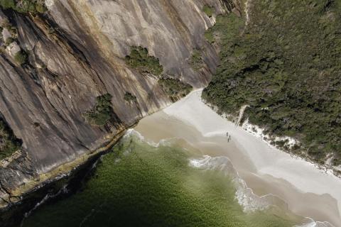 Looking down on a cliff face with deep green water