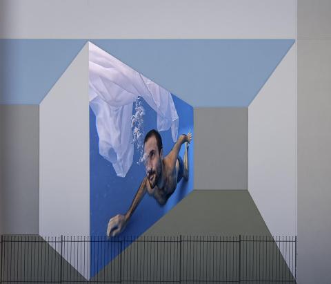Walls of different tones and a person swimming within one wall.
