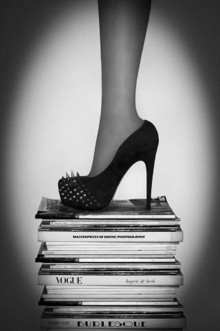 Leg and high heel shoe on a stack of books