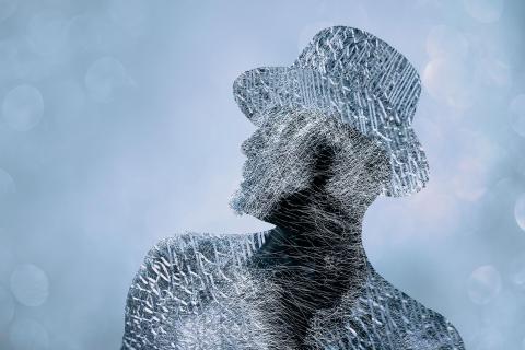 An outline of a person in a hat with a shadow area in the neck and chest area