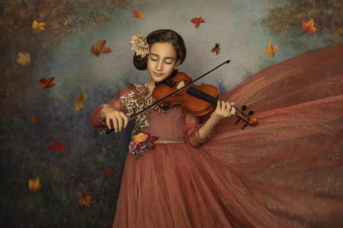 A girl playing the violin. 